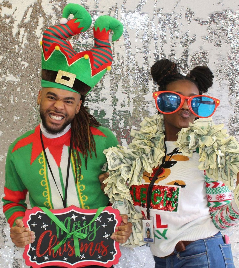 man and woman in christmas attire taking a photo